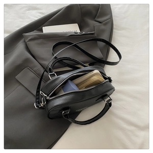 Internal view of black lychee grain leather boston bag showing large storage capacity