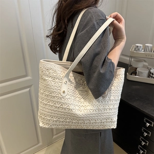 White lace hollow crochet tote bag with leather straps and minimalist brand logo