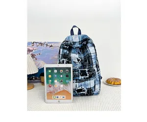 Graffiti denim backpack size comparison with iPad showing retro distressed style