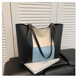 Close-up of tricolor tote bag with PU leather texture and gold metal buckle detail