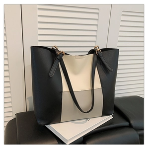 Detail of tricolor leather tote bag with vertical panels and golden metal buckle