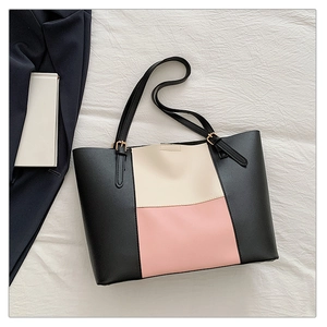 Detailed top view of large tricolor leather tote bag with elegant lychee grain texture