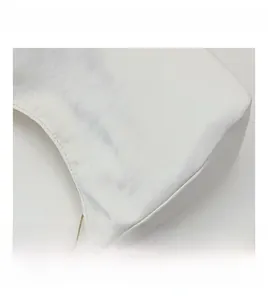 Detail showing the white crescent bag texture with brown side pleats and gold chain strap