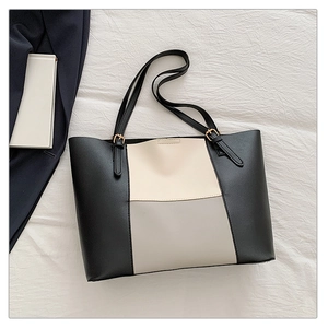 Detailed view of tricolor patchwork tote bag with adjustable gold buckle shoulder strap