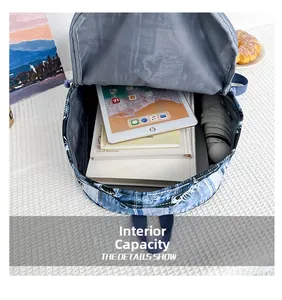 Internal capacity of denim backpack showing space for a tablet, books and umbrella