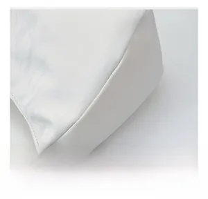 Detailed close-up of premium stitching and white-brown leather contrast on a pillow bag