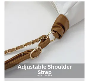 Detail of adjustable PU strap with metal chain and buckle on white tote bag