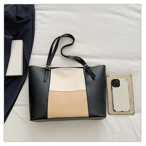 Detailed top view of large tricolor patchwork tote bag with accessories for work