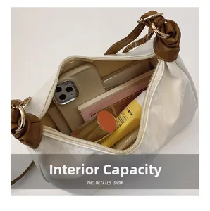 Internal view of a white pillow bag showing large capacity for essentials like smartphone