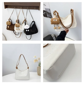 Detail of vintage hobo bags with metal chain straps and plush charms in a lifestyle setting