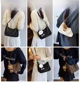 Detail of three colors of crescent bags with plush charms and adjustable shoulder straps