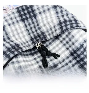Detail view of the smooth dual metal zippers and black-and-white checkered woven fabric