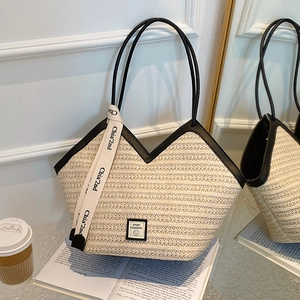 Beige woven tote bag with black leather trim and smile patch for beach or daily commute