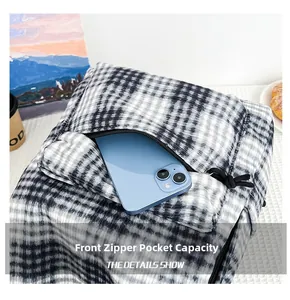 Close-up of the front hidden zipper pocket showing its capacity with a smartphone inside