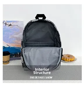 Detailed interior of checkered backpack showing large main compartment and laptop sleeve
