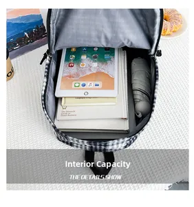 Detailed interior of checkerboard backpack showing storage capacity for tablet and books