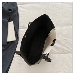 Interior view of black tote bag showing spacious capacity and gold magnetic closure buckle