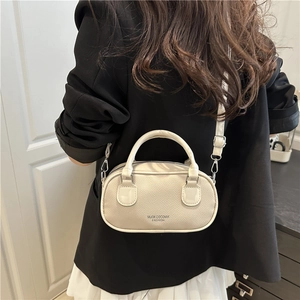 Retro cream white leather bowling bag with top handle and crossbody strap for women