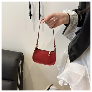 Detailed view of a red lychee pattern leather mini hobo bag with a gold metal zipper