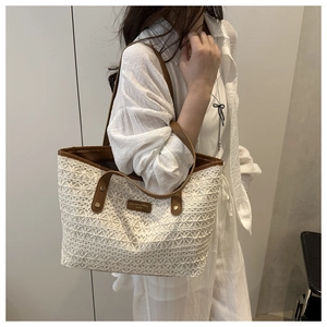Close-up of woven crochet tote bag with brown leather details and brand logo patch