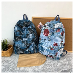 Detail view of denim backpacks featuring vintage patchwork and rose floral prints