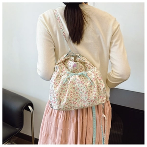 Floral drawstring canvas backpack with pink flowers and light blue checkered bow detail