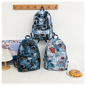 Detailed view of canvas backpacks with vintage patchwork and floral rose print patterns