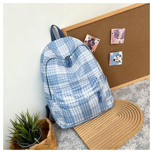 Detailed close-up of blue and white checkered canvas backpack on lifestyle background