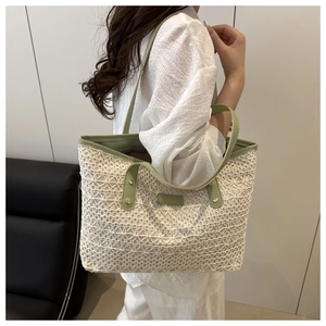 Detail of white lace crochet tote bag with mint green leather straps and gold rivets