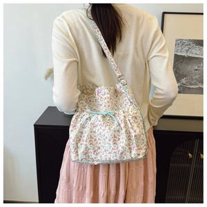 Floral canvas tote bag with light blue bow detail shown on shoulder for size reference