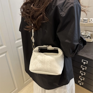 White snakeskin embossed box bag shown as a crossbody purse on a fashion model