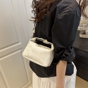 Minimalist white faux leather shoulder bag with snake pattern and adjustable strap