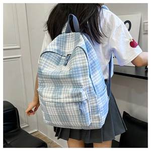 Blue and white plaid canvas backpack shown on a model from a back-view perspective