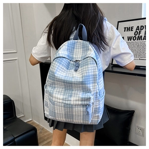 Detail view of a blue checkered backpack showing large capacity and adjustable straps