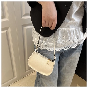 Detailed macro view of white litchi pattern leather and golden zipper on mini bag