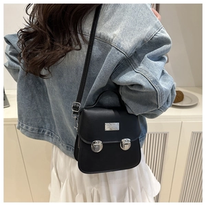 Chic black vintage square handbag shown with a denim jacket for a casual fashion look