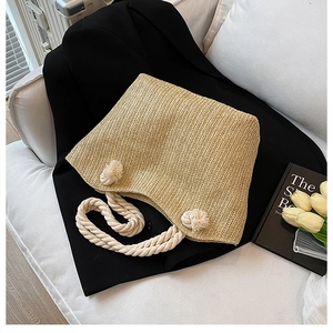 Close-up of hand-woven straw tote with thick cotton rope handles and V-shape textures