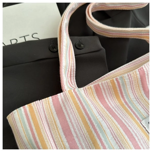 Detailed macro view of multi-color striped canvas tote showing high-quality fabric texture