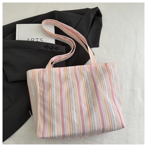 Detailed macro shot of striped canvas tote bag with textured colorful vertical patterns