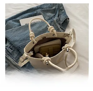 Internal capacity of the cream white crossbody bag showing phone and wallet
