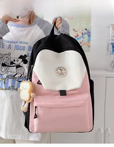 Close-up of tricolor nylon backpack featuring toast plush charm and fashion patch