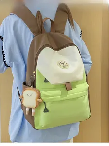 Detail of color-block nylon backpack with a cute plush toast pendant and fashion patch