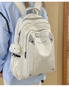 Detail of off-white waterproof nylon backpack with grey drawstrings and cloud pendant