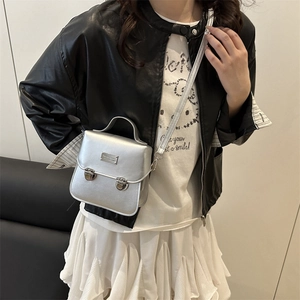 Silver vintage bucket messenger bag with top handle and metal buckle strap details