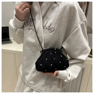 Detailed view of black floral bucket bag with a dainty white flower print design