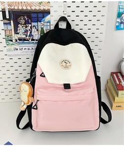 Detail of color-block school backpack with cute toast plush charm and fashion patch