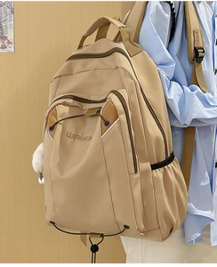 Detailed side view of beige large capacity backpack with LUIFANO logo and plush charm