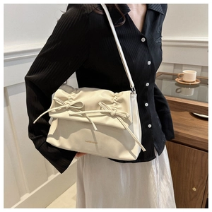 Elegant beige PU leather shoulder bag with chic bow details and fashion lettering