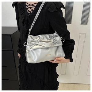 Detail of silver metallic tote bag featuring side bows and Fashion & Bags logo