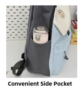 Detail of color-block backpack side pocket holding a pink water bottle for storage